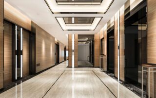 a hotel hallway with perspective view looking toward the elevator